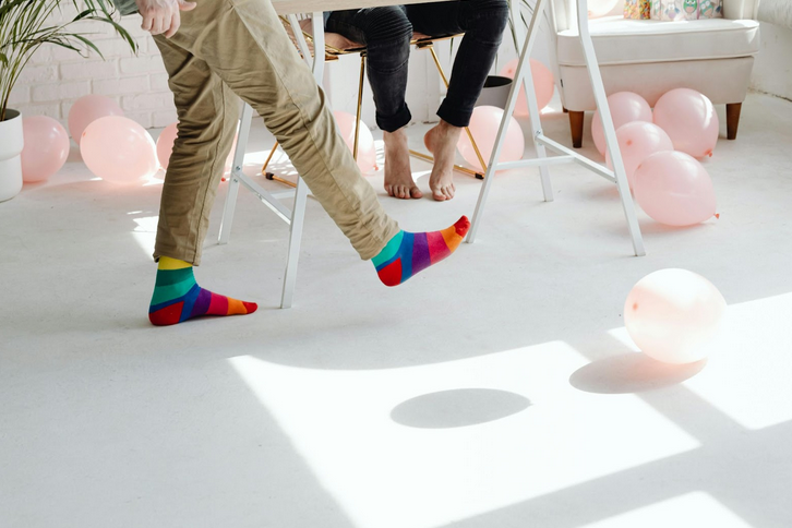 person playfully walking with colorful socks