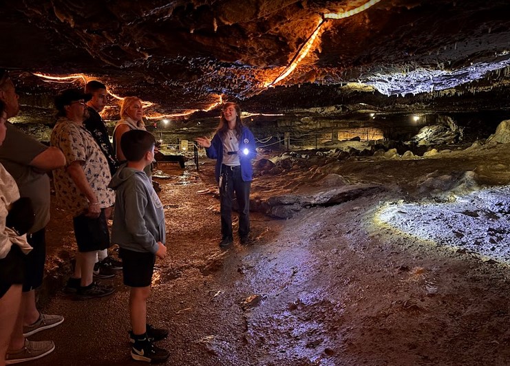 Visitors exploring Perry’s Cave at Put-in-Bay with limestone formations, underground lake, and guided tour.