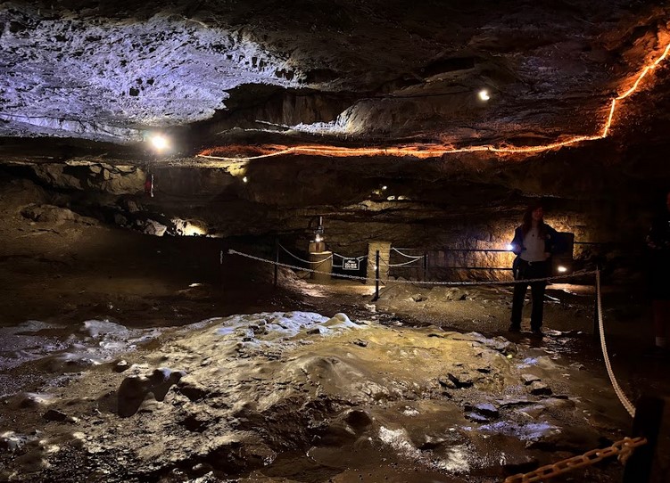Visitors exploring Perry’s Cave at Put-in-Bay with limestone formations, underground lake, and guided tour.