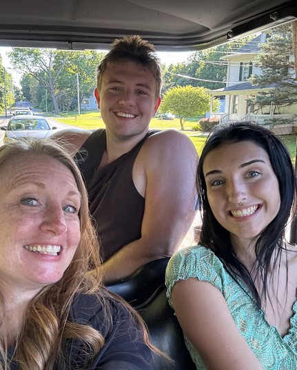 Family driving an E’s Golf Cart around Put-in-Bay attractions and lakefront views.