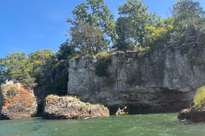 Kayakers paddling at Kayak the Bay in Put-in-Bay with Lake Erie in the background.