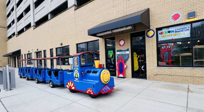 picture of ride-on train in front of Akron Children's Museum for Akron Express Rails & Runways event