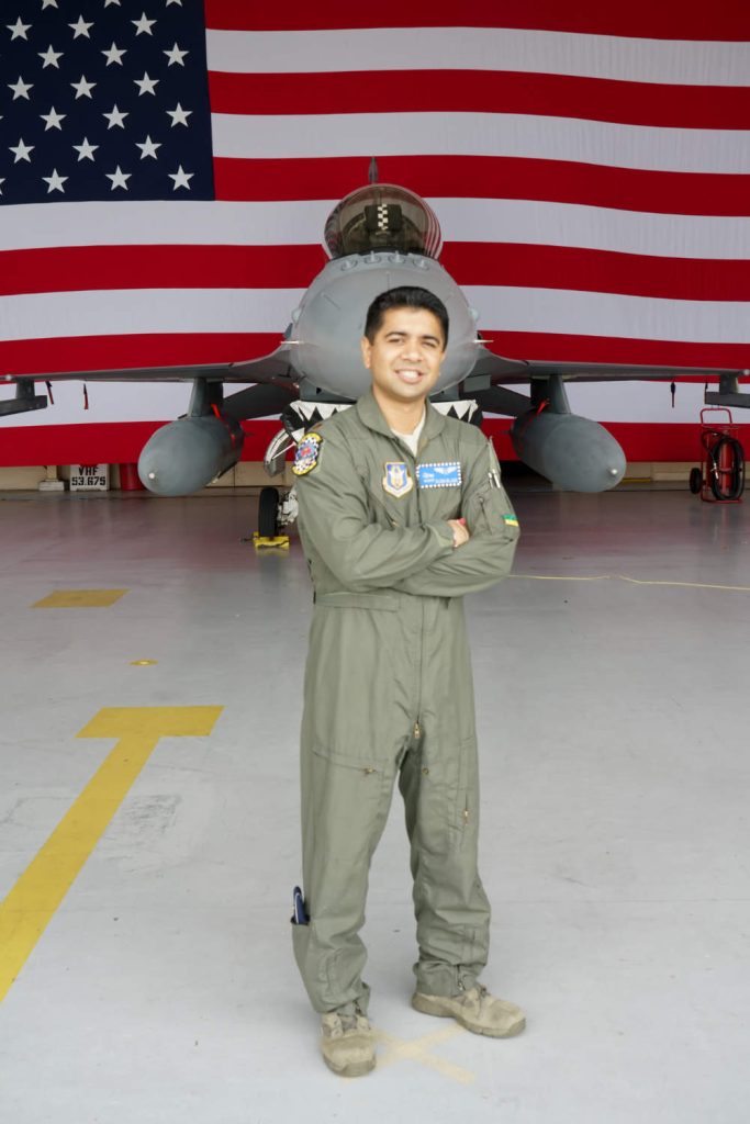 picture of Dr. Avishek Kumar in front of Air Force plane and American Flag