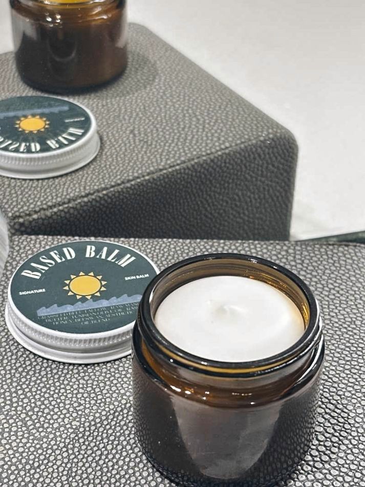 A jar of Based Balm beef tallow on a wooden table, the best natural moisturizer for Akron winters.