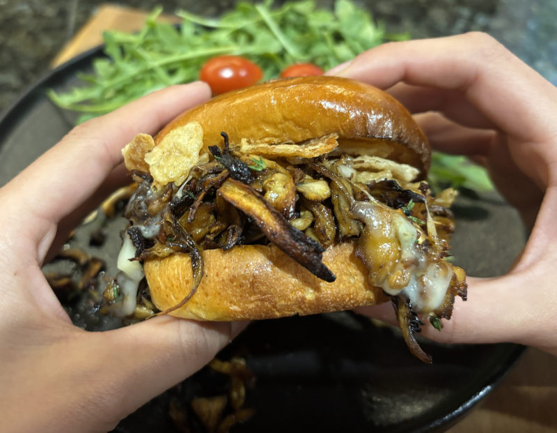 picture of brioche bun with cooked mushrooms like look like pulled pork