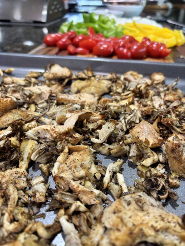 picture of Roasted Mushrooms and cut vegetables on a bar