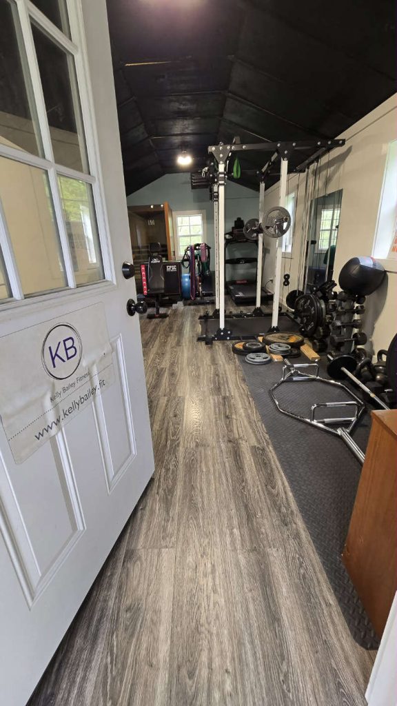 The welcoming entrance to Kelly Bailey Fitness in Spencer, Ohio, featuring the KB logo and website on the door.