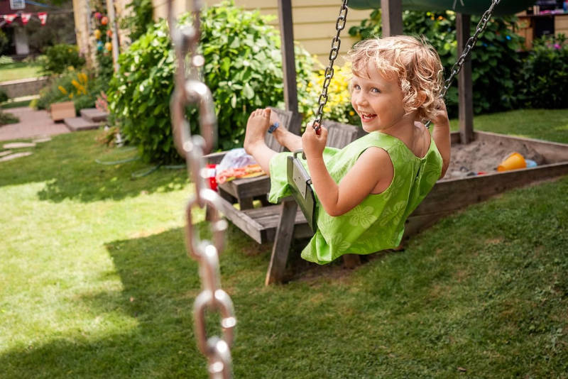 girl on swing backyard