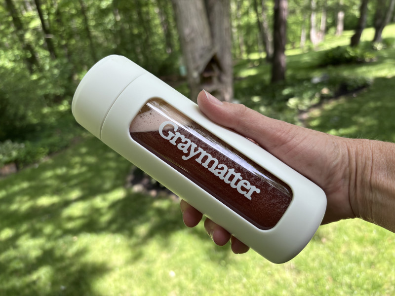 bottle of prepared Graymatter Bright Mind product with a green back yard