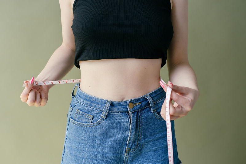 weightloss image woman with tape measurer