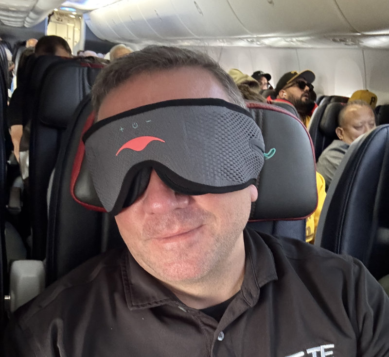man wearing Manta Sound Mask on airplane
