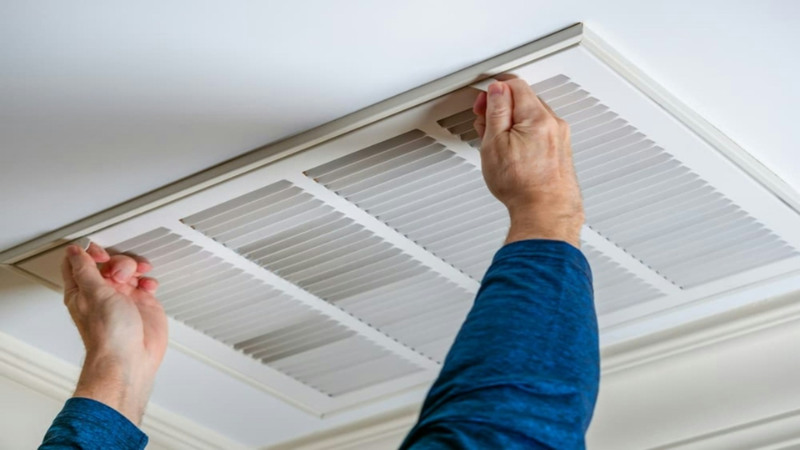 person holding airduct vent hvac