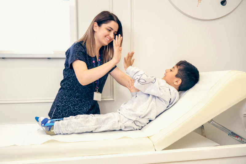 nurse giving high five to child patient