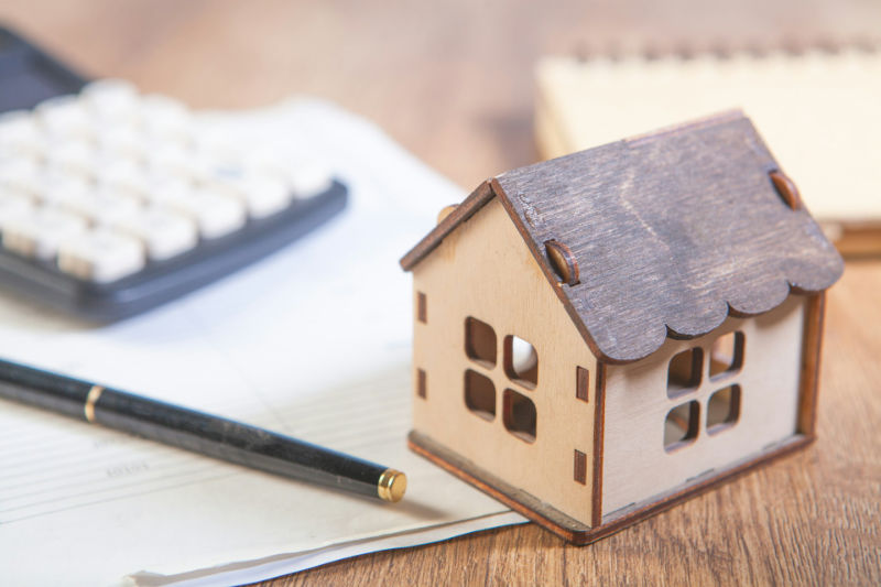 Small house with computer keyboard mortgage