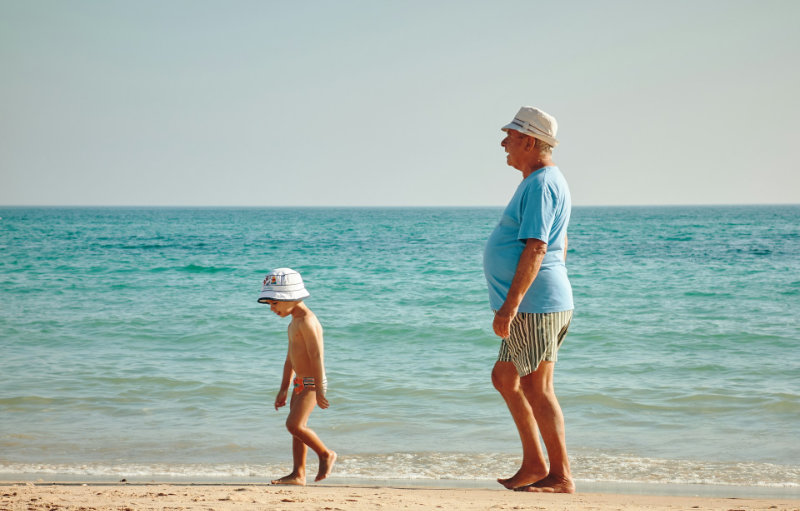grandpa with grandson at beach