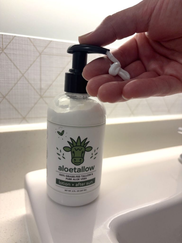 squirting aloetallow lotion on hand