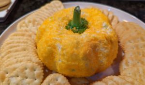 Pumpkin Shaped Cheese Ball with crackers on plate